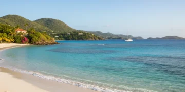 Panoramic view of Trunk Bay, St. John, US Virgin Islands, with clear turquoise water and white sandy beach.